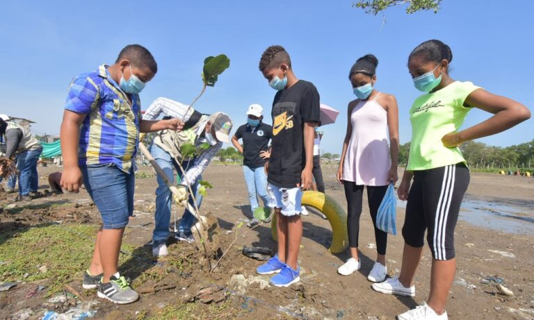 funcionarios y comunidad en siembra de árboles
